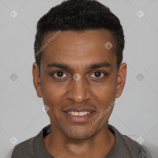 Joyful black young-adult male with short  black hair and brown eyes