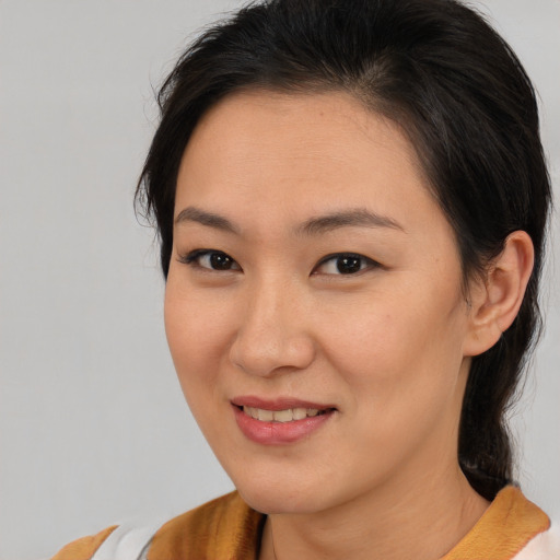 Joyful asian young-adult female with medium  brown hair and brown eyes
