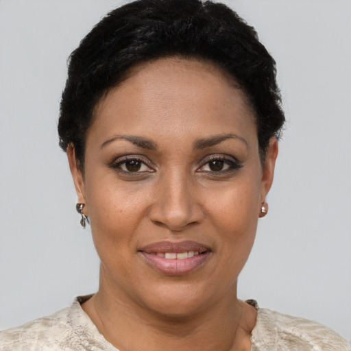 Joyful black young-adult female with short  brown hair and brown eyes
