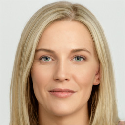 Joyful white young-adult female with long  brown hair and green eyes