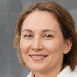 Joyful white adult female with medium  brown hair and brown eyes