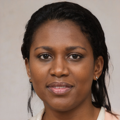 Joyful black young-adult female with medium  brown hair and brown eyes