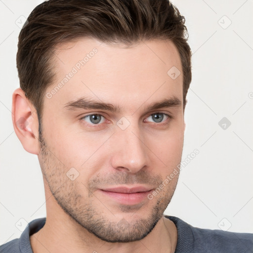 Joyful white young-adult male with short  brown hair and grey eyes