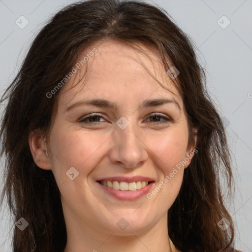 Joyful white adult female with long  brown hair and brown eyes