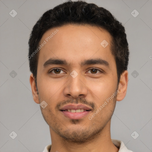 Joyful latino young-adult male with short  black hair and brown eyes