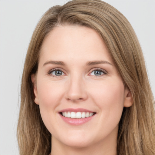 Joyful white young-adult female with long  brown hair and grey eyes