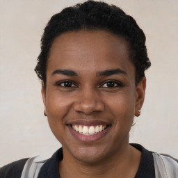 Joyful black young-adult female with short  black hair and brown eyes