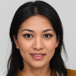 Joyful asian young-adult female with long  brown hair and brown eyes