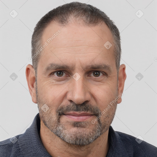 Joyful white adult male with short  brown hair and brown eyes