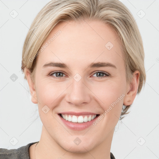 Joyful white young-adult female with medium  brown hair and blue eyes