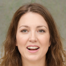 Joyful white young-adult female with long  brown hair and green eyes