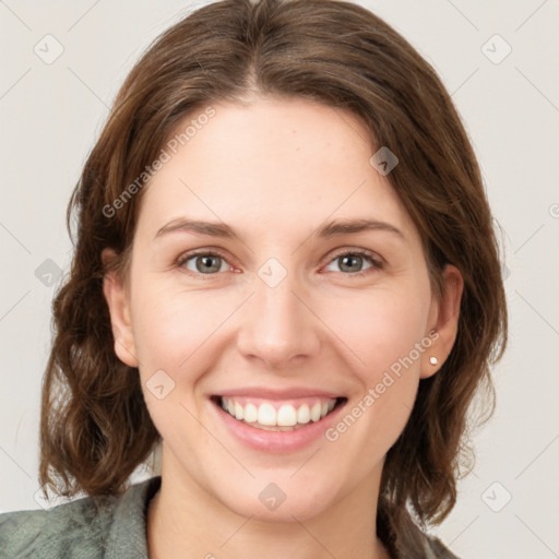 Joyful white young-adult female with medium  brown hair and green eyes