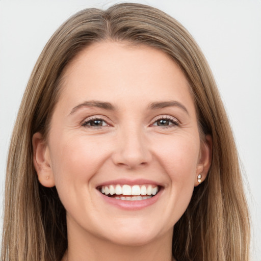 Joyful white young-adult female with long  brown hair and grey eyes