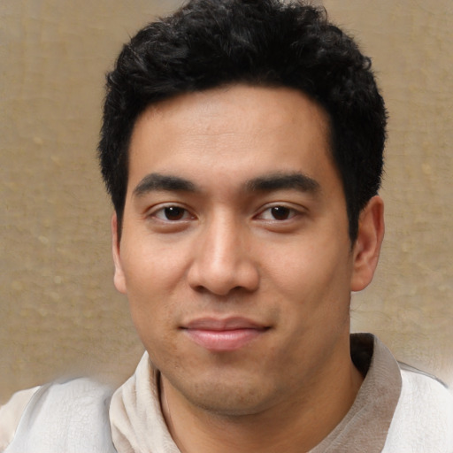 Joyful asian young-adult male with short  black hair and brown eyes