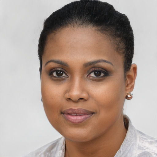 Joyful black young-adult female with short  brown hair and brown eyes