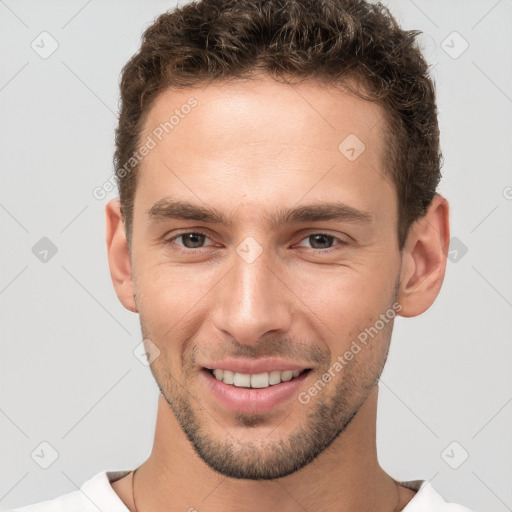 Joyful white young-adult male with short  brown hair and brown eyes