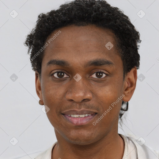 Joyful black young-adult male with short  brown hair and brown eyes