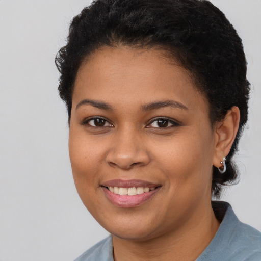 Joyful latino young-adult female with short  brown hair and brown eyes