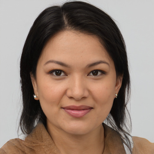 Joyful latino young-adult female with medium  brown hair and brown eyes
