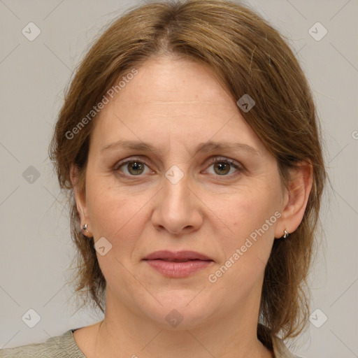 Joyful white adult female with medium  brown hair and green eyes