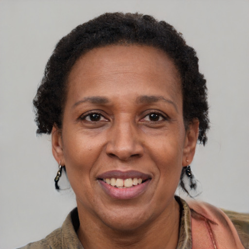Joyful latino adult female with short  brown hair and brown eyes