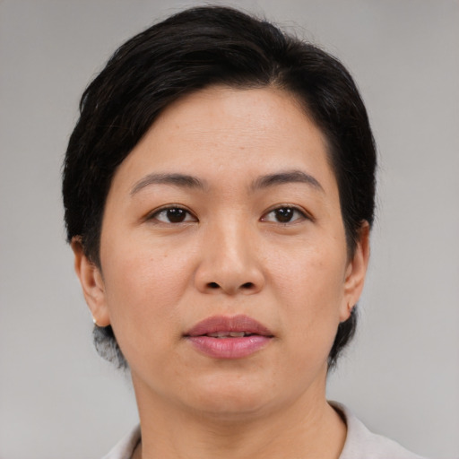 Joyful asian adult female with short  brown hair and brown eyes