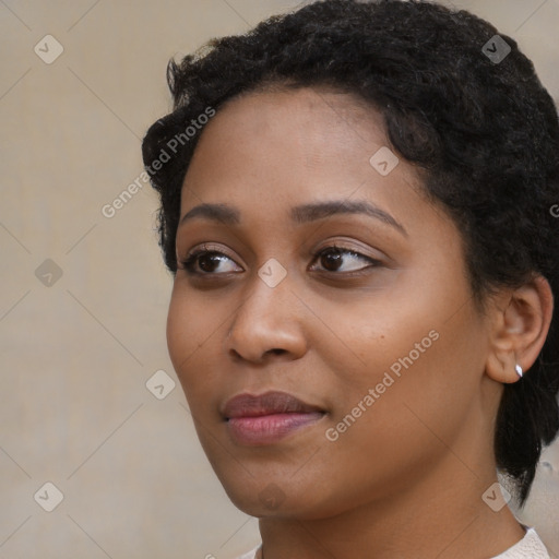 Joyful black young-adult female with short  black hair and brown eyes