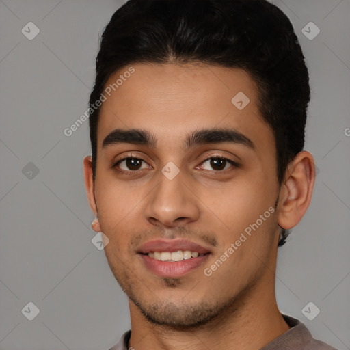 Joyful white young-adult male with short  black hair and brown eyes