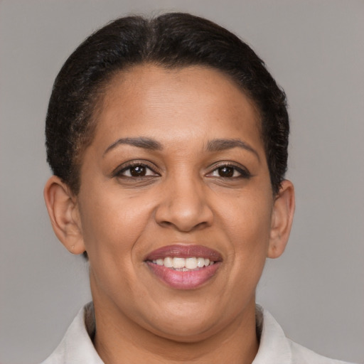 Joyful latino adult female with short  brown hair and brown eyes