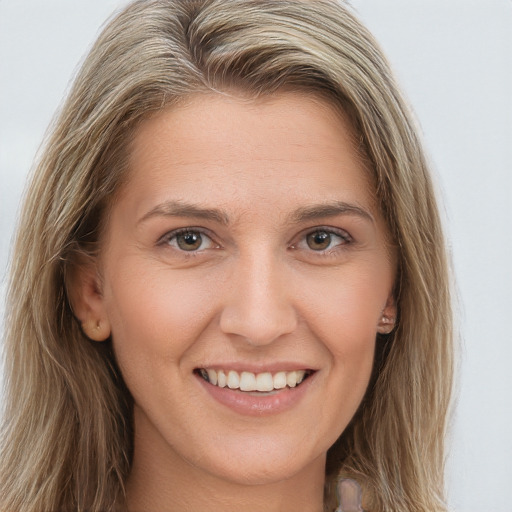 Joyful white young-adult female with long  brown hair and brown eyes