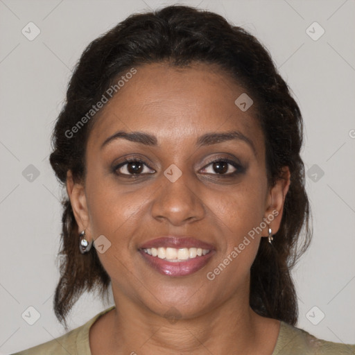 Joyful black adult female with medium  brown hair and brown eyes