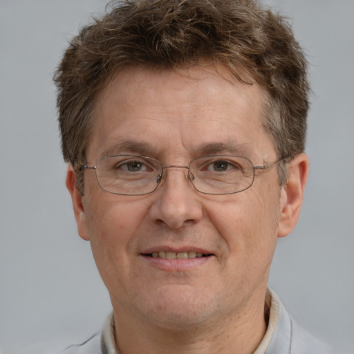 Joyful white adult male with short  brown hair and grey eyes