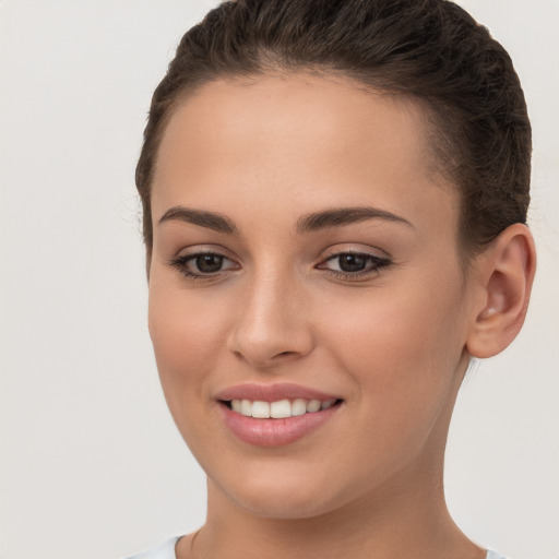 Joyful white young-adult female with short  brown hair and brown eyes