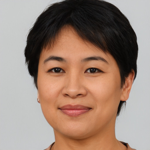 Joyful asian young-adult female with medium  brown hair and brown eyes