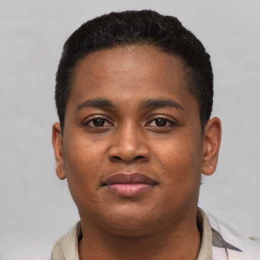 Joyful black young-adult male with short  brown hair and brown eyes