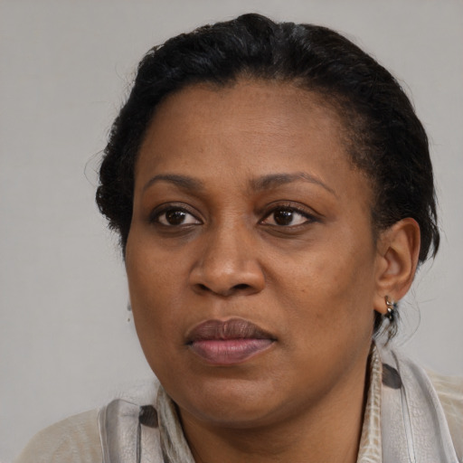 Joyful black adult female with short  brown hair and brown eyes