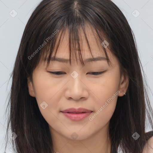 Joyful asian young-adult female with long  brown hair and brown eyes