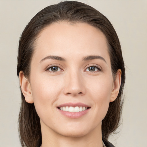 Joyful white young-adult female with medium  brown hair and brown eyes