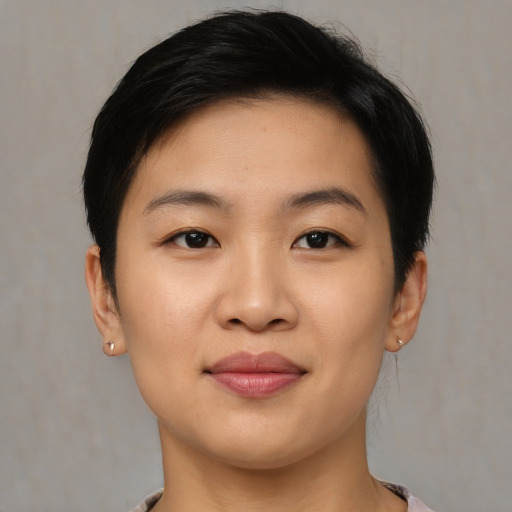 Joyful asian young-adult female with short  black hair and brown eyes