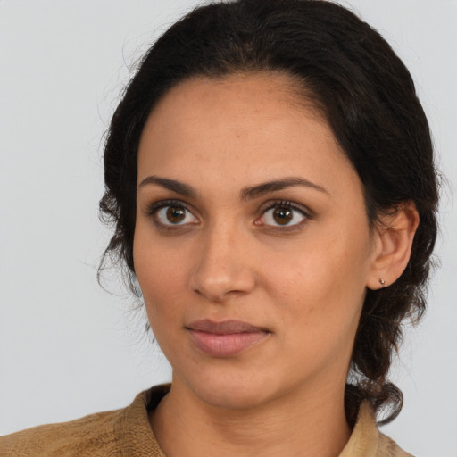 Joyful latino young-adult female with medium  brown hair and brown eyes