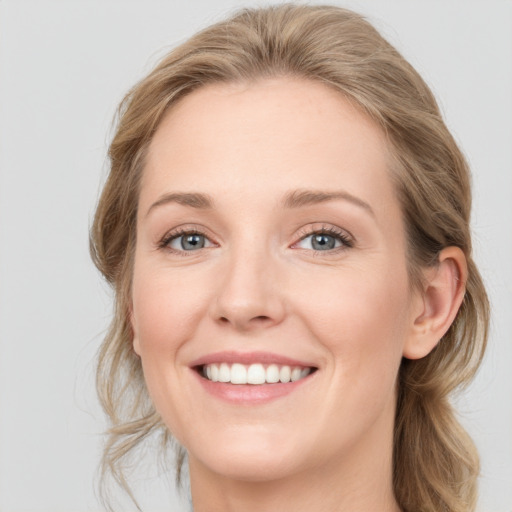 Joyful white young-adult female with medium  brown hair and blue eyes