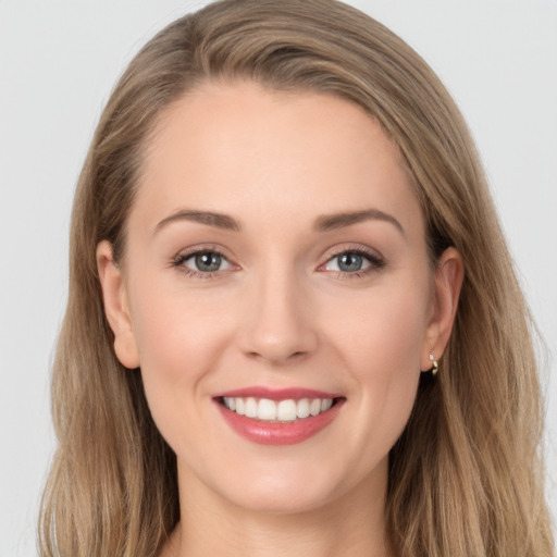 Joyful white young-adult female with long  brown hair and grey eyes