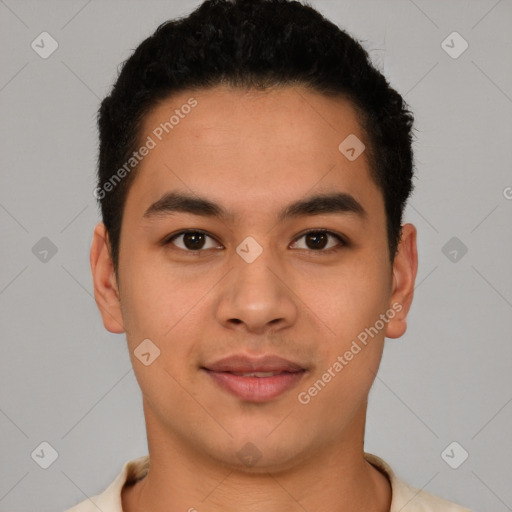 Joyful latino young-adult male with short  brown hair and brown eyes