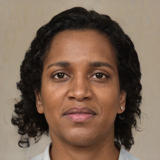 Joyful black young-adult female with medium  brown hair and brown eyes