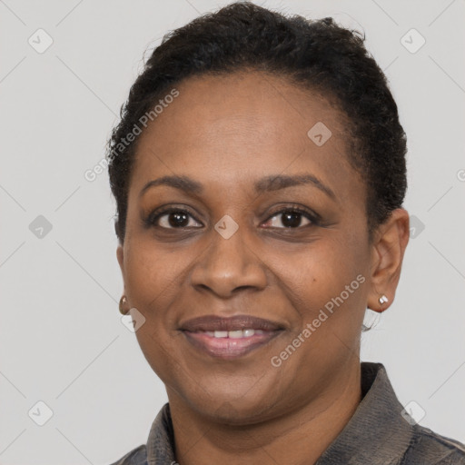 Joyful black adult female with short  brown hair and brown eyes