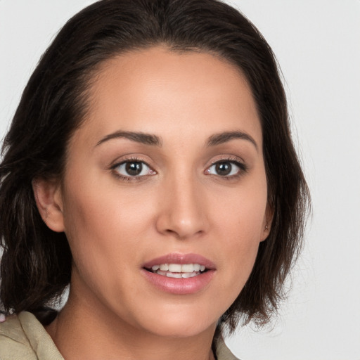 Joyful white young-adult female with medium  brown hair and brown eyes