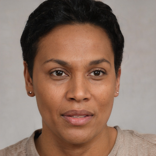Joyful latino adult female with short  black hair and brown eyes