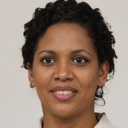 Joyful black young-adult female with short  brown hair and brown eyes