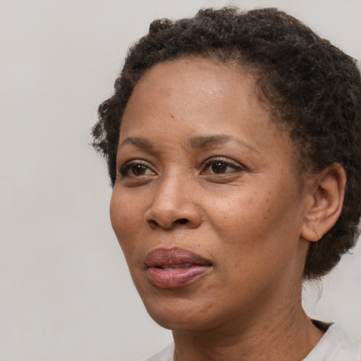 Neutral black adult female with short  brown hair and brown eyes