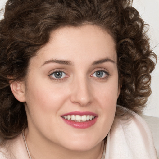 Joyful white young-adult female with medium  brown hair and green eyes